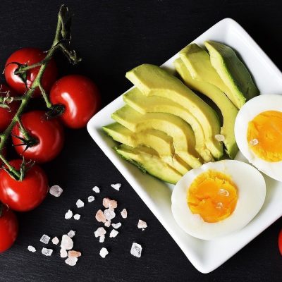 A healthy snack of tomatoes, avocado and boiled eggs