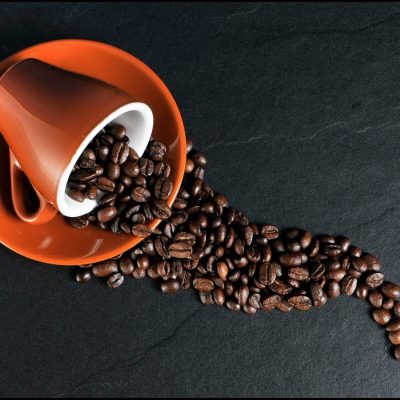 Coffee beans spilling out of a mug